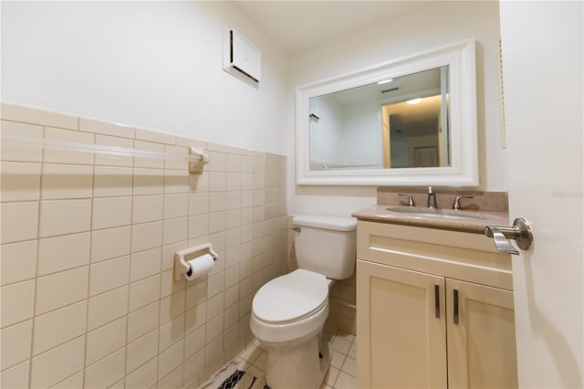 821 Orchid Springs Dr Unit 821, Winter Haven, FL 33884 - half bathroom featuring toilet, tile patterned floors, tile walls, vanity, and wainscoting