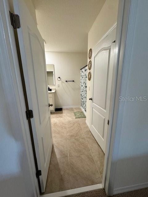 full bathroom with vanity, tile patterned flooring, baseboards, and a shower with shower curtain