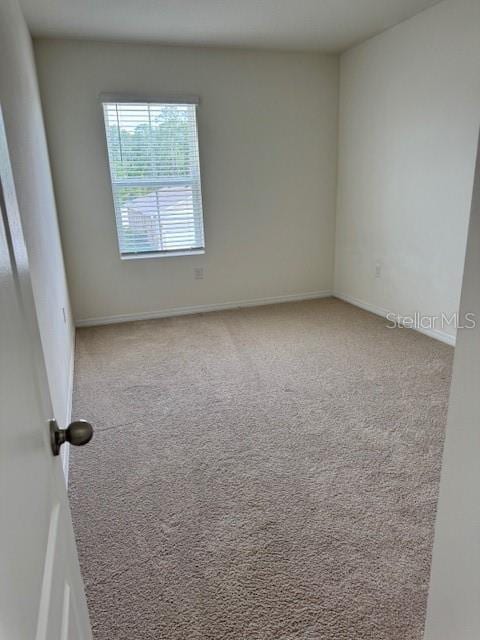 spare room with carpet floors and baseboards