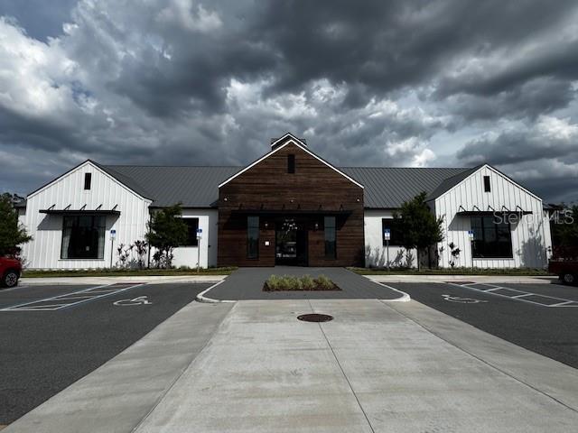 view of building exterior with uncovered parking