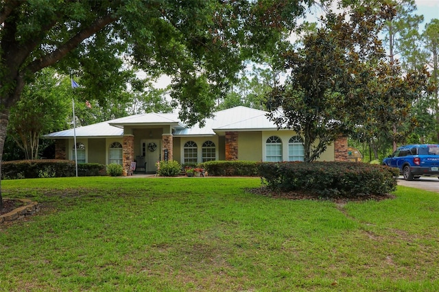 9365 Lemon Dr, Lake Wales, FL 33898 - ranch-style home with a front lawn, stone siding, and stucco siding