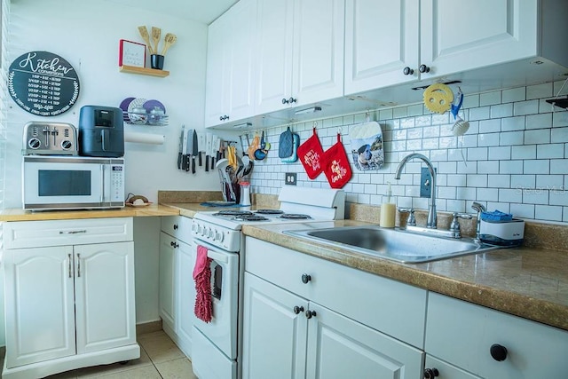 3041 Club Cir, Lake Wales, FL 33898 - kitchen with white appliances, decorative backsplash, white cabinetry, and light tile patterned floors