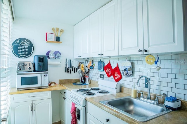 3041 Club Cir, Lake Wales, FL 33898 - kitchen featuring white appliances, decorative backsplash, white cabinets, and light countertops