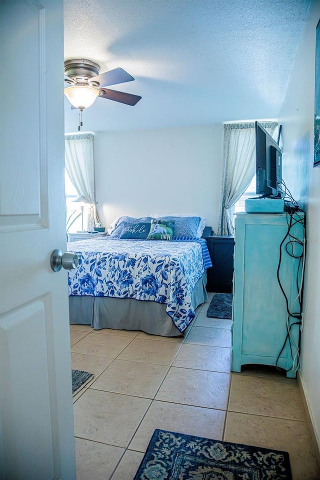 3041 Club Cir, Lake Wales, FL 33898 - bedroom with multiple windows, ceiling fan, a textured ceiling, and light tile patterned floors