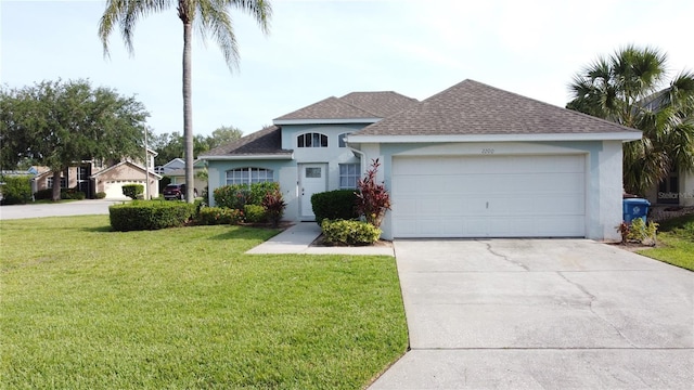 2200 Mallory Cir, Haines City, FL 33844 - view of front of house featuring stucco siding, a shingled roof, a front yard, concrete driveway, and an attached garage