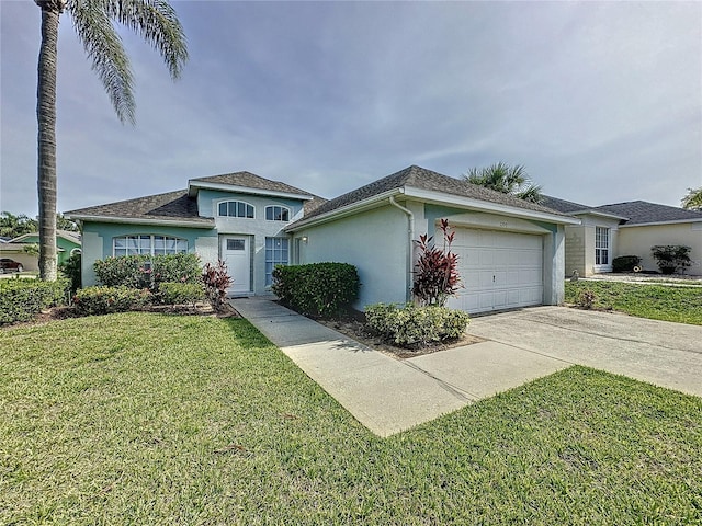 2200 Mallory Cir, Haines City, FL 33844 - view of front of home with stucco siding, an attached garage, concrete driveway, and a front yard