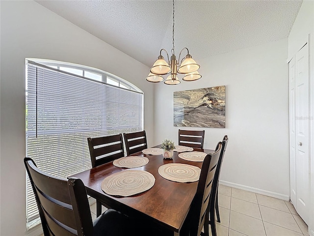 2200 Mallory Cir, Haines City, FL 33844 - dining area with a chandelier, a textured ceiling, light tile patterned flooring, baseboards, and lofted ceiling