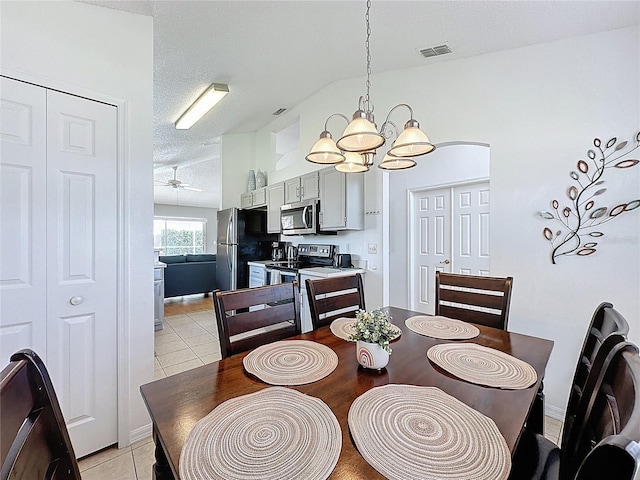 2200 Mallory Cir, Haines City, FL 33844 - dining room with a chandelier, light tile patterned floors, a textured ceiling, and a ceiling fan
