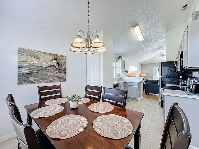 2200 Mallory Cir, Haines City, FL 33844 - dining space with a chandelier, a textured ceiling, light tile patterned flooring, washer / clothes dryer, and vaulted ceiling