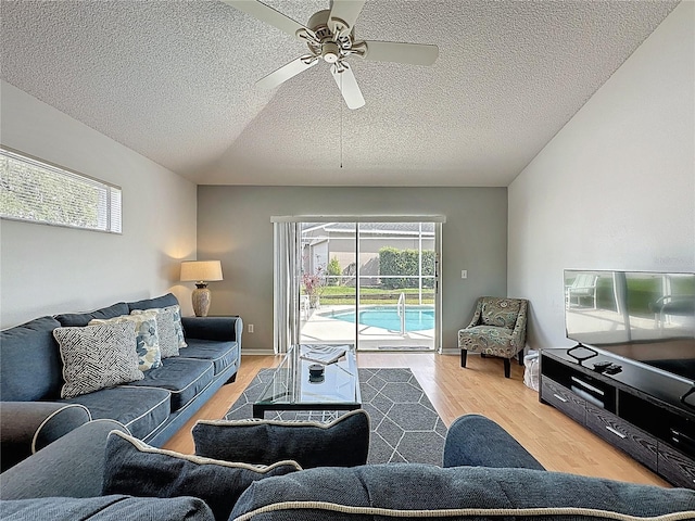 2200 Mallory Cir, Haines City, FL 33844 - living room with a textured ceiling, ceiling fan, plenty of natural light, and light wood-style flooring