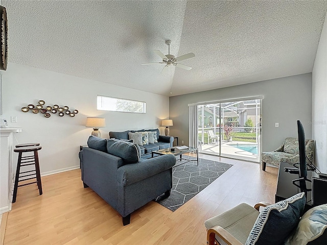 2200 Mallory Cir, Haines City, FL 33844 - living room with ceiling fan, a textured ceiling, light wood-style floors, and plenty of natural light