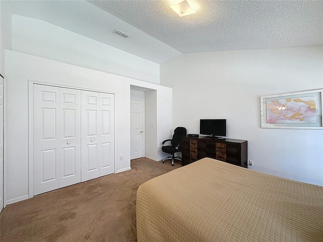 2200 Mallory Cir, Haines City, FL 33844 - carpeted bedroom with vaulted ceiling, a closet, and a textured ceiling