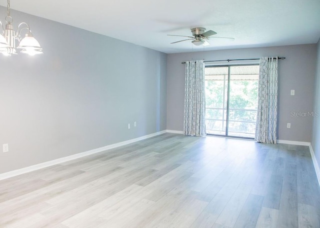 130 E Johnson Ave Unit 206, Lake Wales, FL 33853 - unfurnished room with a ceiling fan, a chandelier, baseboards, and light wood-type flooring