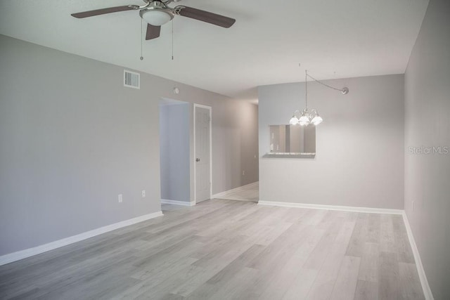 130 E Johnson Ave Unit 206, Lake Wales, FL 33853 - spare room with a ceiling fan, a chandelier, light wood-type flooring, and baseboards