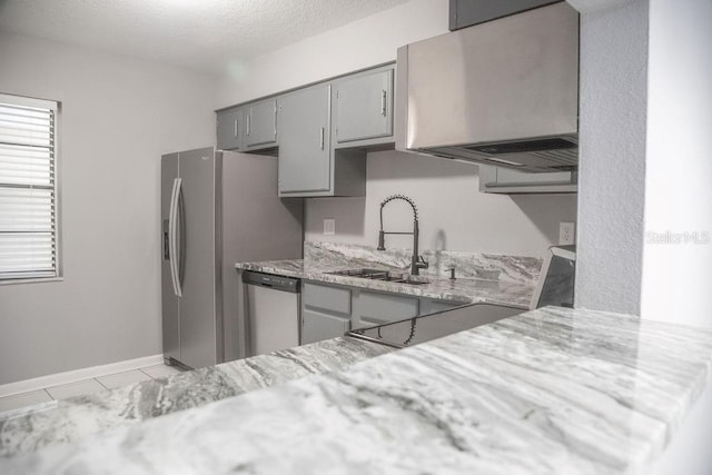 130 E Johnson Ave Unit 206, Lake Wales, FL 33853 - kitchen featuring gray cabinetry, appliances with stainless steel finishes, a sink, baseboards, and light stone counters