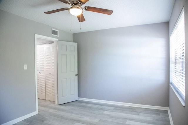 130 E Johnson Ave Unit 206, Lake Wales, FL 33853 - empty room featuring plenty of natural light, a ceiling fan, wood finished floors, and baseboards
