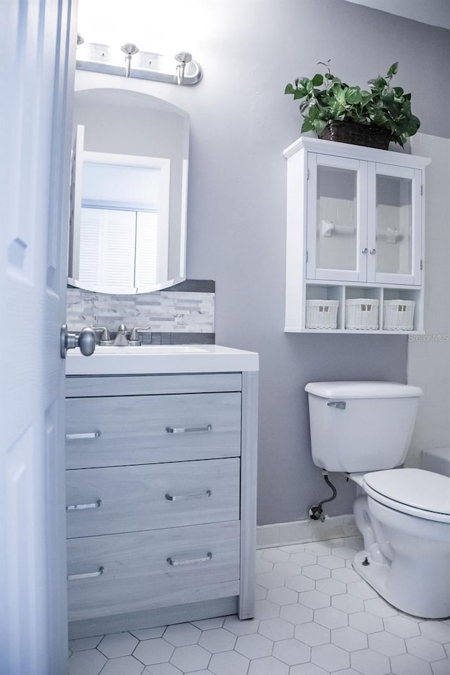 130 E Johnson Ave Unit 206, Lake Wales, FL 33853 - bathroom featuring toilet, vanity, tile patterned floors, and baseboards