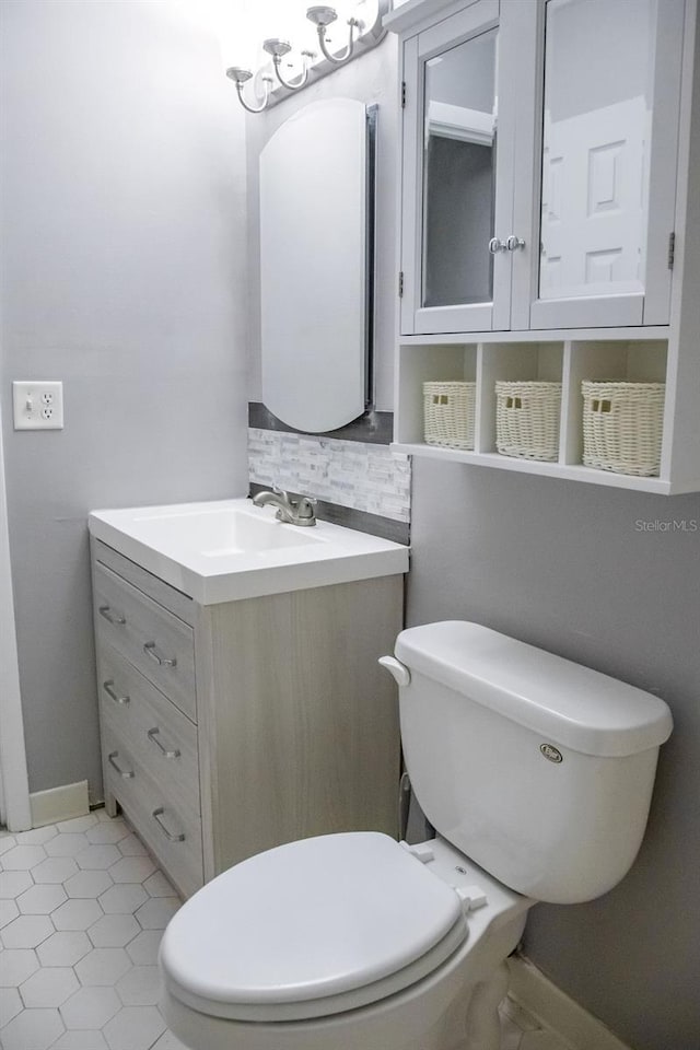 130 E Johnson Ave Unit 206, Lake Wales, FL 33853 - half bath featuring toilet, vanity, decorative backsplash, and baseboards