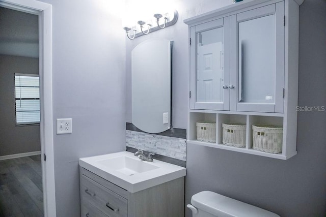 130 E Johnson Ave Unit 206, Lake Wales, FL 33853 - half bath featuring decorative backsplash, toilet, vanity, and wood finished floors