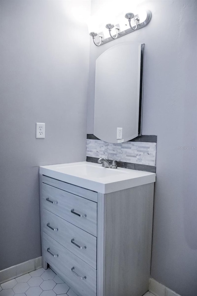130 E Johnson Ave Unit 206, Lake Wales, FL 33853 - bathroom featuring vanity, backsplash, tile patterned flooring, and baseboards