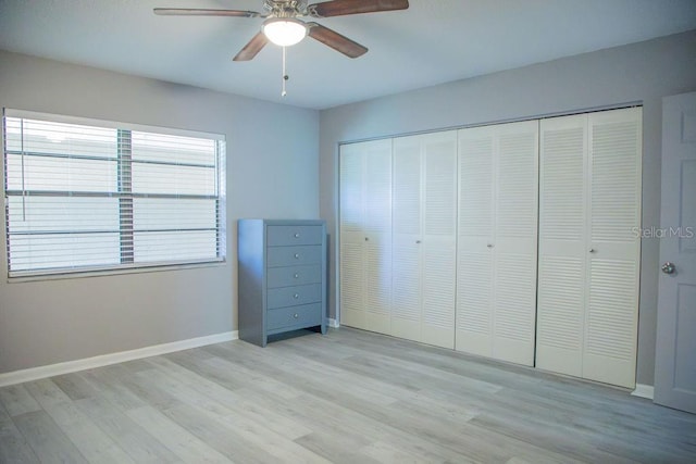 130 E Johnson Ave Unit 206, Lake Wales, FL 33853 - unfurnished bedroom featuring baseboards, light wood-type flooring, a closet, and ceiling fan