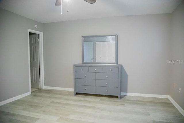 130 E Johnson Ave Unit 206, Lake Wales, FL 33853 - unfurnished bedroom featuring light wood-style floors, baseboards, and a ceiling fan