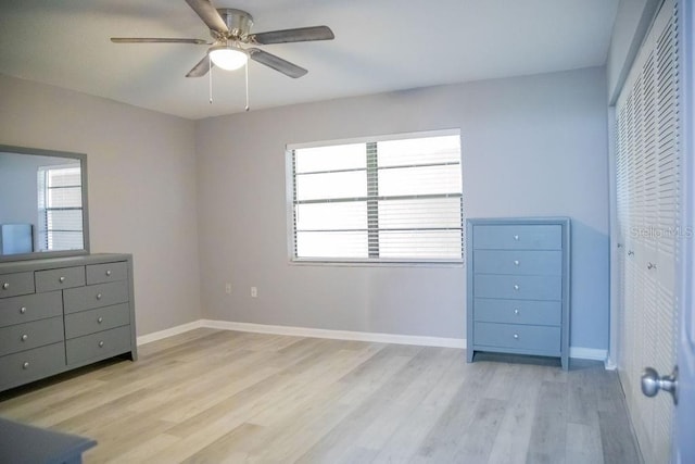 130 E Johnson Ave Unit 206, Lake Wales, FL 33853 - unfurnished bedroom with light wood-style floors, multiple windows, baseboards, and a ceiling fan