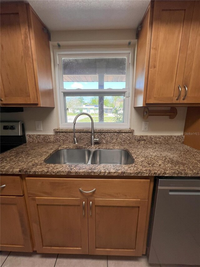 1624 Lagrange Ave, Sebring, FL 33870 - kitchen featuring stainless steel dishwasher, a sink, dark stone countertops, a textured ceiling, and stove