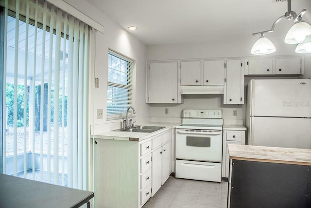 4725 Kayworth Rd, Lake Wales, FL 33898 - kitchen with white appliances, under cabinet range hood, a sink, light tile patterned floors, and pendant lighting