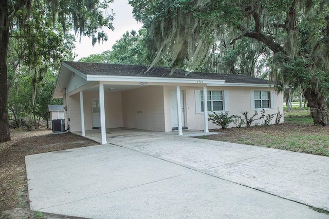 4725 Kayworth Rd, Lake Wales, FL 33898 - single story home featuring concrete driveway, central air condition unit, a carport, and a shingled roof