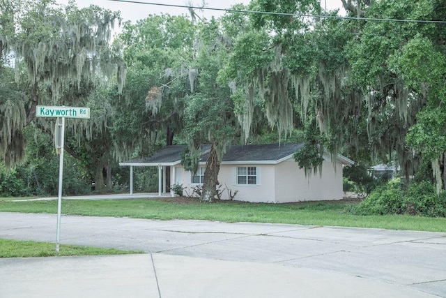 4725 Kayworth Rd, Lake Wales, FL 33898 - view of front of home featuring concrete driveway, a front yard, stucco siding, and an attached carport