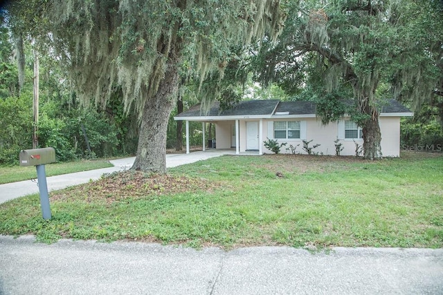 4725 Kayworth Rd, Lake Wales, FL 33898 - ranch-style home with concrete driveway, a carport, a front yard, and stucco siding