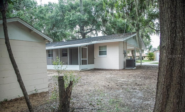 4725 Kayworth Rd, Lake Wales, FL 33898 - view of side of home with a sunroom, central AC, concrete block siding, and a shingled roof