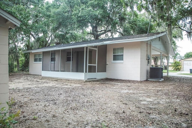 4725 Kayworth Rd, Lake Wales, FL 33898 - rear view of property with a sunroom, central air condition unit, and concrete block siding