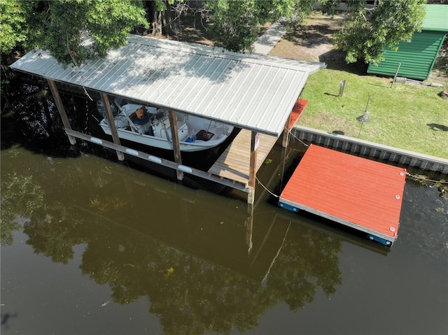 1422 Ave H SW, Winter Haven, FL 33880 - dock area featuring boat lift, a water view, and a lawn
