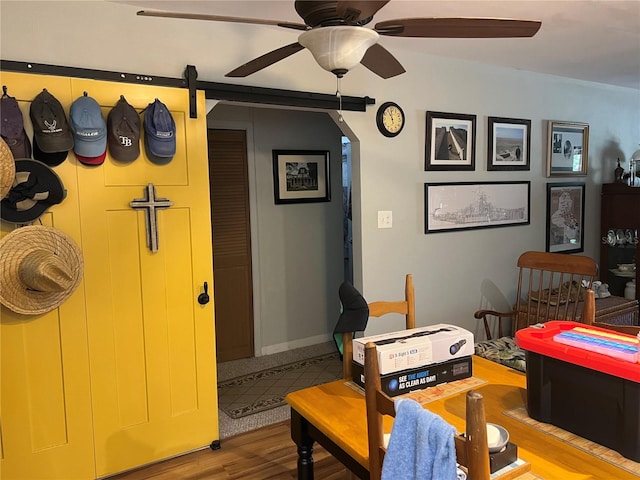 1422 Ave H SW, Winter Haven, FL 33880 - dining space with ceiling fan, wood finished floors, a barn door, and arched walkways
