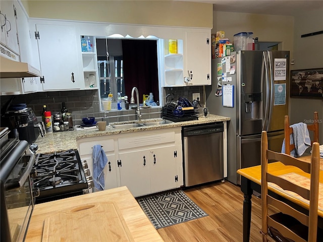 1422 Ave H SW, Winter Haven, FL 33880 - kitchen with open shelves, appliances with stainless steel finishes, a sink, backsplash, and white cabinets