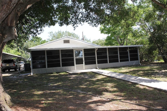 1422 Ave H SW, Winter Haven, FL 33880 - back of property featuring a sunroom and a detached carport