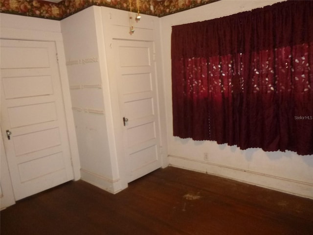 302 S Palm Ave, Frostproof, FL 33843 - spare room featuring dark wood-style floors and baseboards