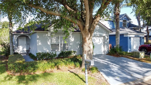 2696 Hemingway Ave, Haines City, FL 33844 - view of front of house with concrete driveway, a garage, stucco siding, and roof with shingles