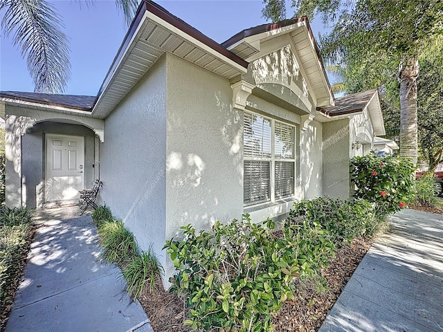 2696 Hemingway Ave, Haines City, FL 33844 - view of side of home featuring stucco siding and roof with shingles