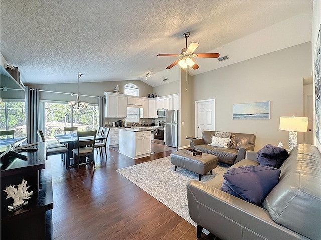 2696 Hemingway Ave, Haines City, FL 33844 - living area with vaulted ceiling, ceiling fan, a textured ceiling, dark wood-type flooring, and a chandelier