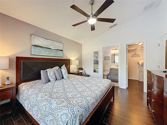 2696 Hemingway Ave, Haines City, FL 33844 - bedroom with vaulted ceiling, dark wood finished floors, a ceiling fan, a walk in closet, and connected bathroom