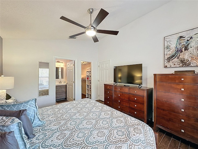 2696 Hemingway Ave, Haines City, FL 33844 - bedroom featuring lofted ceiling, connected bathroom, a walk in closet, and ceiling fan