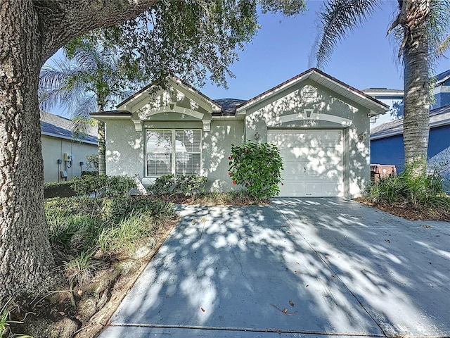 2696 Hemingway Ave, Haines City, FL 33844 - view of front facade featuring stucco siding, a garage, and concrete driveway