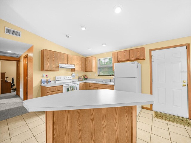 2568 Tall Palm Ave, Lake Wales, FL 33898 - kitchen with white appliances, under cabinet range hood, light countertops, light tile patterned floors, and lofted ceiling