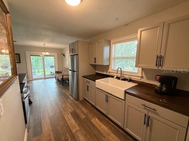 1885 Pfundstein Rd, Babson Park, FL 33827 - kitchen featuring freestanding refrigerator, wood finished floors, hanging light fixtures, butcher block countertops, and a chandelier