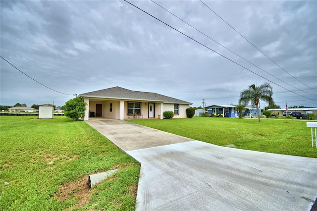 10 Armbruster Ct, Frostproof, FL 33843 - single story home featuring driveway, a front yard, an attached carport, and stucco siding