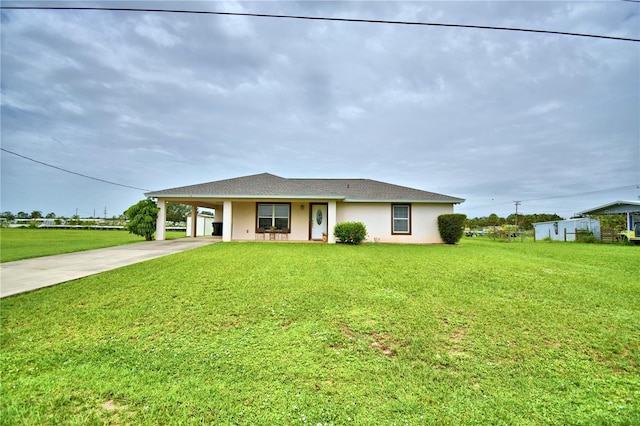 10 Armbruster Ct, Frostproof, FL 33843 - view of front of home with concrete driveway, a front yard, an attached carport, and stucco siding