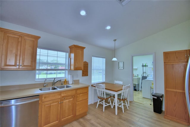 10 Armbruster Ct, Frostproof, FL 33843 - kitchen with stainless steel dishwasher, washer / clothes dryer, light wood-style floors, vaulted ceiling, and light countertops